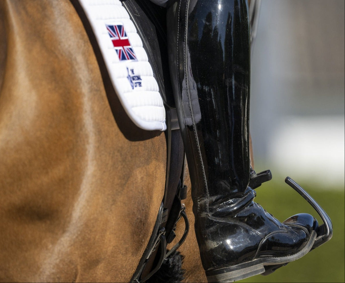 Riding boot resting in a RYDE stirrup