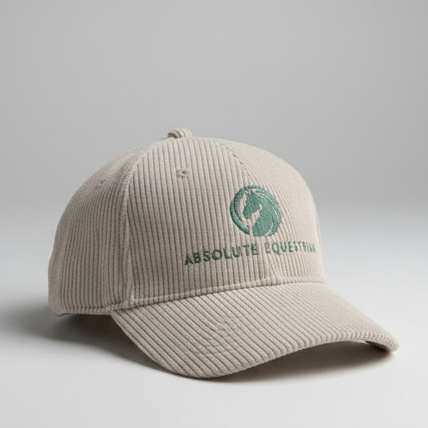A light beige corduroy cap with Absolute Equestrian branding 