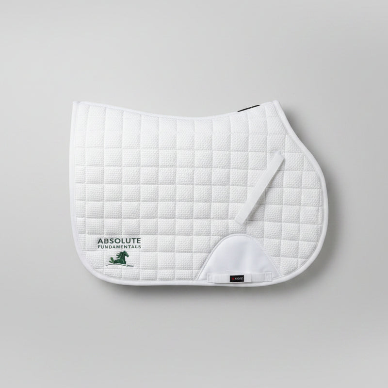 A white quilted equestrian saddle pad with a white leather girth loop and the Absolute Fundamentals logo